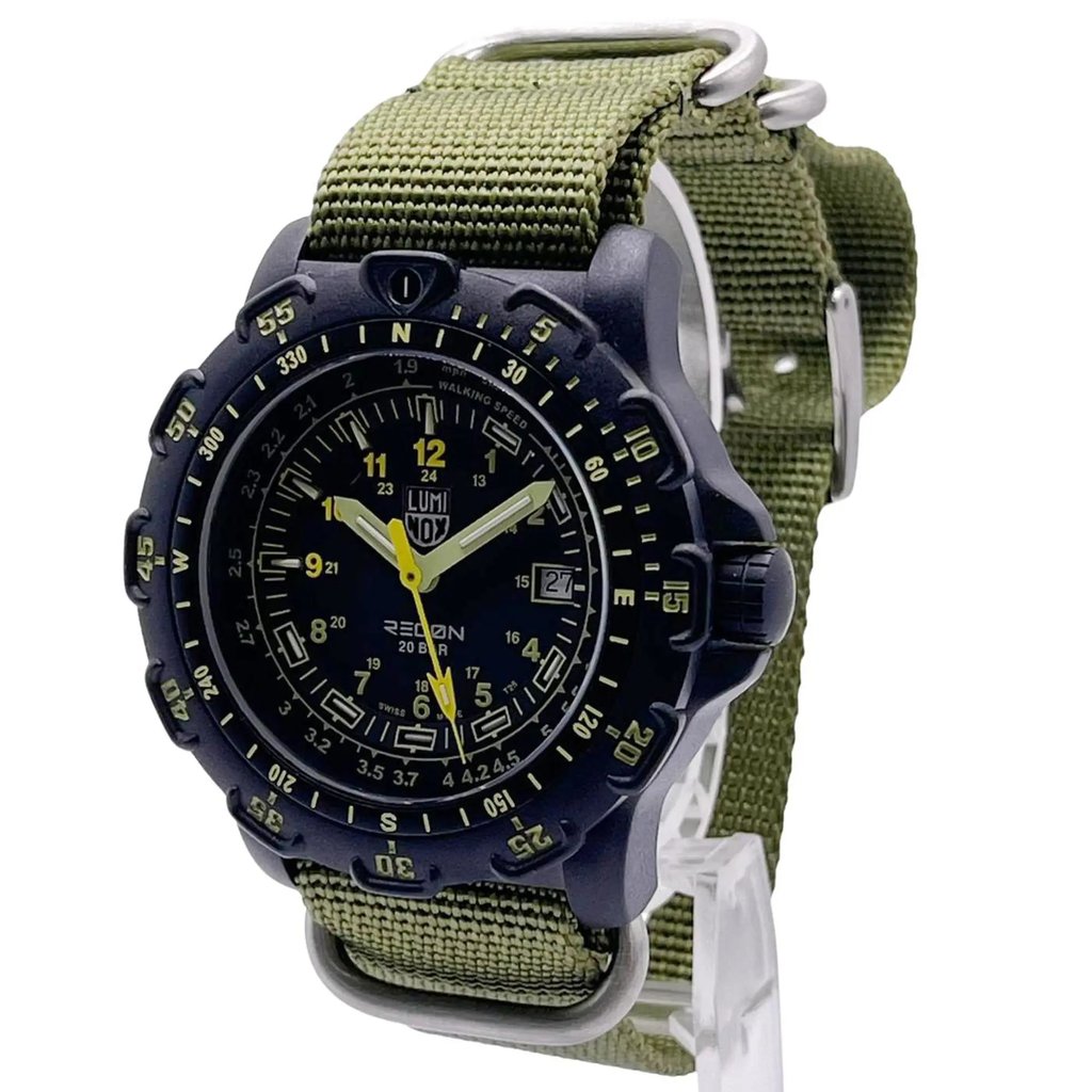 An image of a Wristwatch by Luminox. This Display Model item is designed for Men, featuring a Casual,Classic,Diver,Dress/Formal,Military,Sport style. It has a Quartz movement and an Analog display with a Black dial color. The indices include 12-Hour Dial,24-Hour Dial,Arabic Numerals,Stick Indexes. The band is made of Nylon and the case is made of Carbon. The watch has a Round shape with a case size of 45 mm and a case thickness of 13 mm.