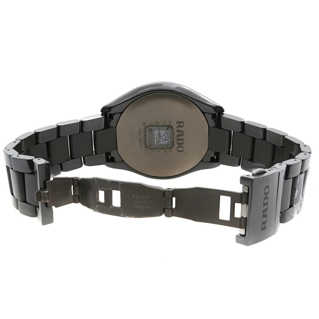 An image of a wristwatch seen from the back view, showcasing an open clasp. The watch is positioned to display its metallic bracelet links and the case back, with the brand name visible. The angle is slightly elevated, and the distance allows for a clear view of the clasp mechanism and details on the case back. The watch is a display model, indicating pristine condition.