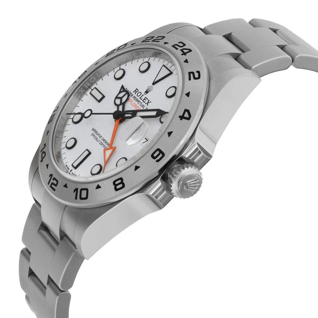 An image of a pre-owned wristwatch from a side profile view, highlighting the crown prominently. The watch has a metallic bracelet and a white dial with black numerals and markers. The angle showcases the thickness of the watch casing and the detailed design of the crown. The image captures the watch from a close distance, emphasizing its polished finish and intricate details.