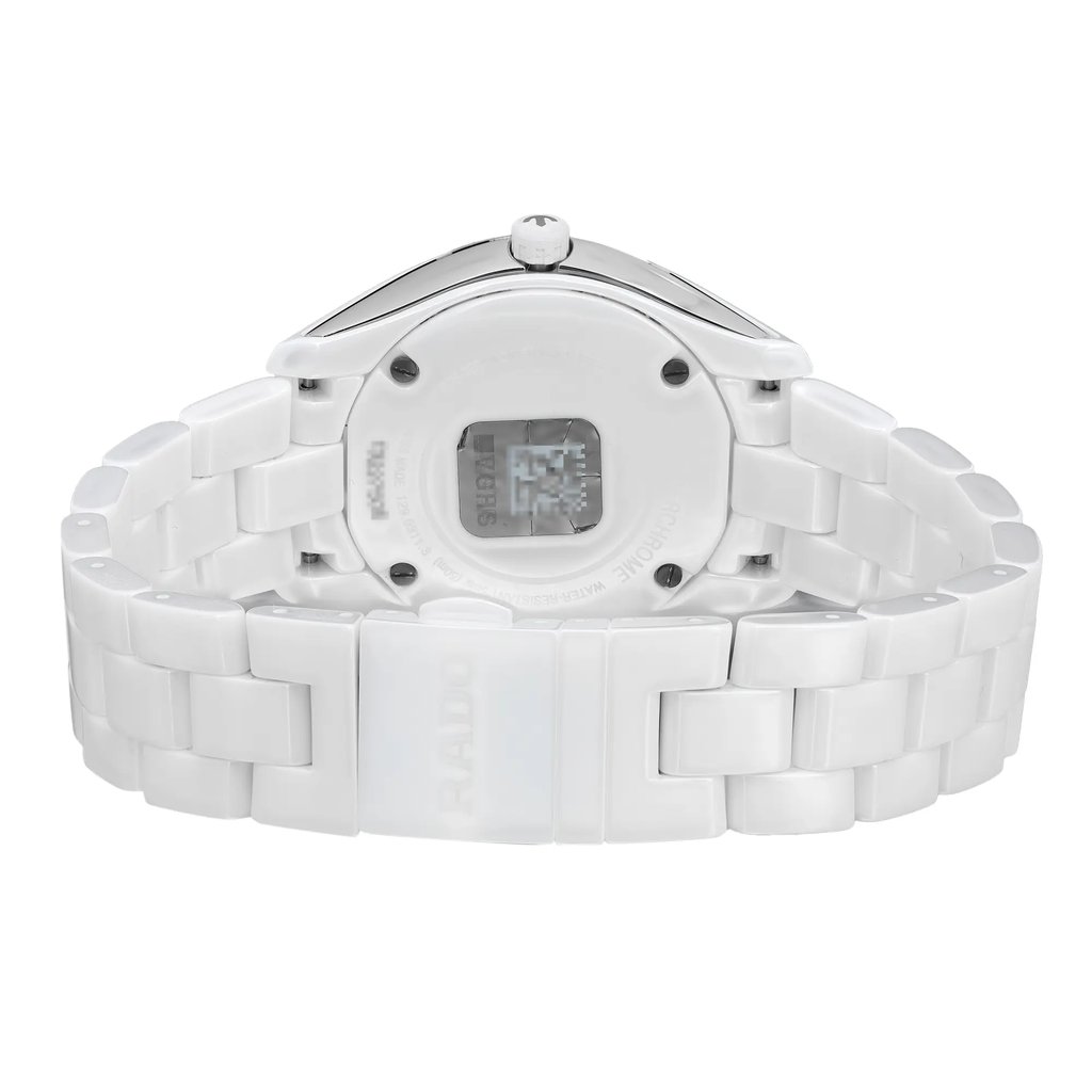 An image of an unworn Rado women's wristwatch showcasing the back view with a closed clasp. The watch features a round shape, a screwback case made of ceramic and stainless steel, and a ceramic band. It is designed with a fold-over clasp with double push-button closure. The angle of the photo is a close-up, centered on the watch's caseback, with the band extending to the sides of the frame, The watch is depicted against a white background.