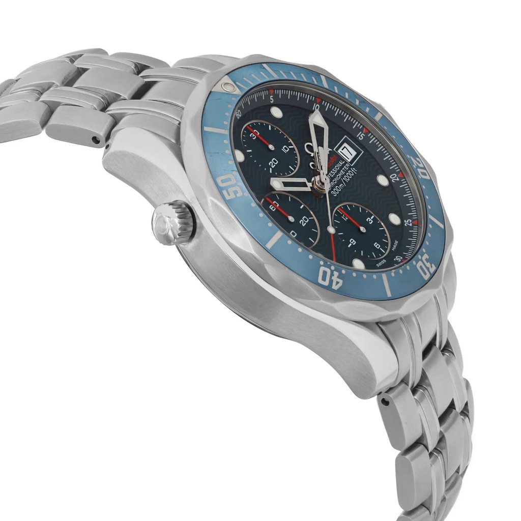 An image of a pre-owned wristwatch captured from a side profile view, opposite the crown. The watch features a metal bracelet and a round bezel with a blue insert. The face displays multiple subdials and a date window, adding to its intricate design. The angle highlights the watch's thickness and craftsmanship, taken from a close distance to emphasize detail.