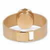 An image of a pre-owned Patek Philippe unisex wristwatch. The watch is positioned with its back facing the viewer, showcasing the closed clasp and textured yellow gold band. The angle is slightly above and from behind, providing a clear view of the back of the watch case and the intricate mesh pattern of the bracelet. The photograph is taken at a close distance, emphasizing the details of the watch's design.