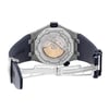 An image of a pre-owned wristwatch showing the back view with an open clasp. The watch is positioned at a slight angle, showcasing the intricate design of the exposed movement and the engraved brand name "Royal Oak Offshore" on the case back. The clasp is fully extended, emphasizing the metal links and the navy blue strap. The photo is taken from a close distance, highlighting the details of the watch's craftsmanship.
