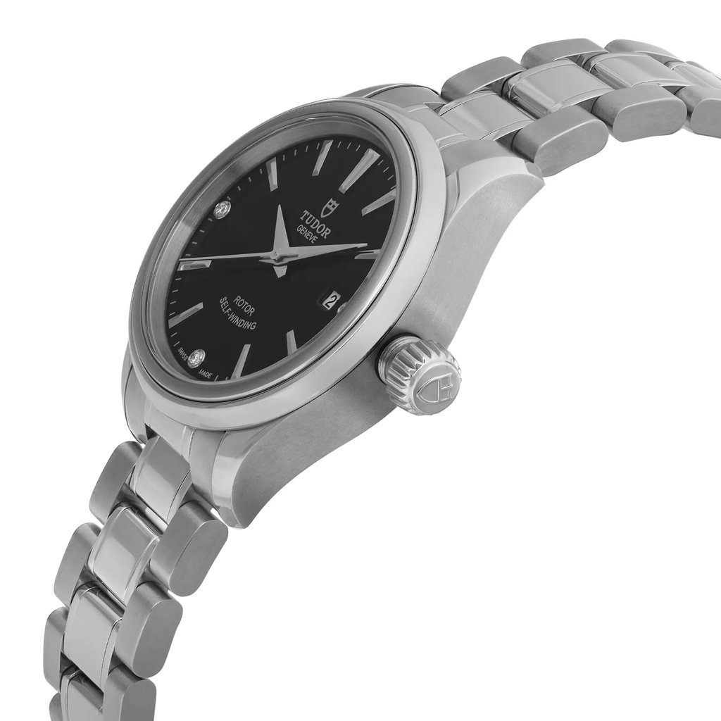 An image of a wristwatch taken from a side profile view, highlighting the unworn condition. The crown is prominently displayed, showcasing its intricate detailing. The watch features a sleek metal bracelet and a dark dial with minimalistic markers. The angle and proximity emphasize the craftsmanship and design of the timepiece.