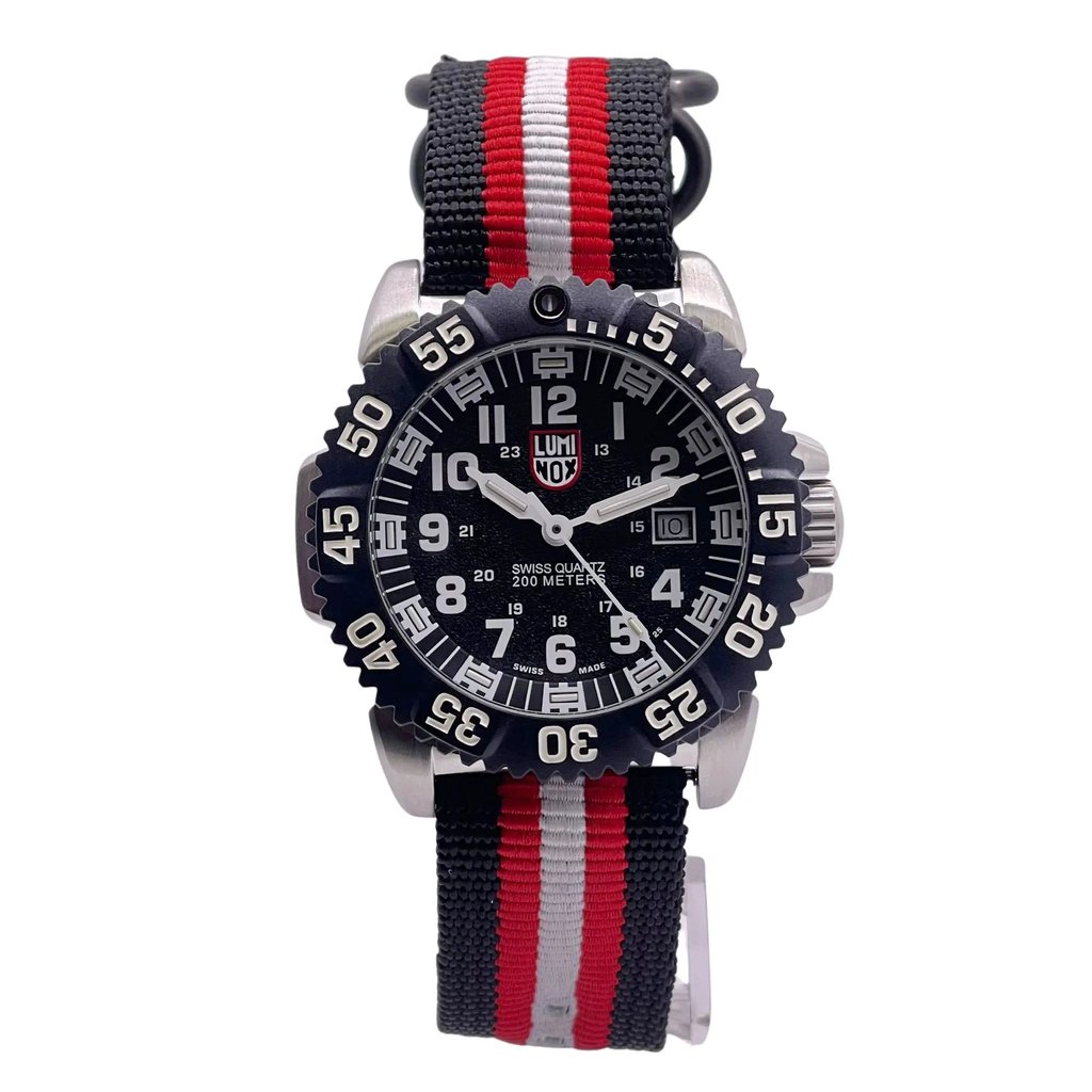 An image of a Wristwatch by Luminox. This Pre Owned item is designed for Men, featuring a Casual,Classic,Dress/Formal,Luxury,Military,Sport style. It has a Quartz movement and an Analog display with a Black dial color. The indices include 12-Hour Dial,Arabic Numerals. The band is made of Nylon and the case is made of Stainless Steel. The watch has a Round shape with a case size of 45 mm and a case thickness of 13 mm.