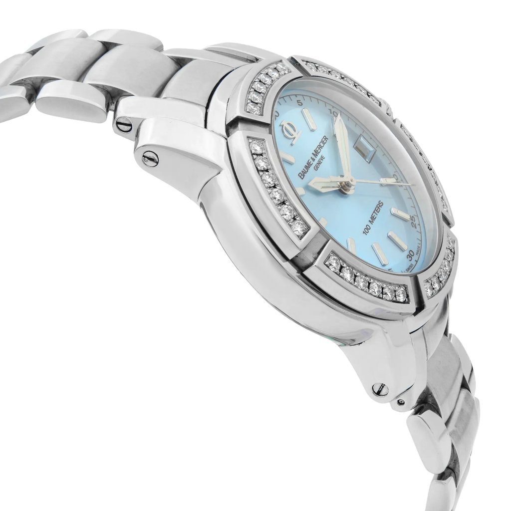 An image of a pre-owned wristwatch shown from a side profile view, opposite the crown. The angle highlights the watch's elegant design, with a focus on its metallic links and the intricately detailed case. The face of the watch is visible in a light blue color, adorned with sparkling embellishments around the bezel. The watch is positioned at a slight angle, capturing a close-up perspective that emphasizes its luxurious appearance.