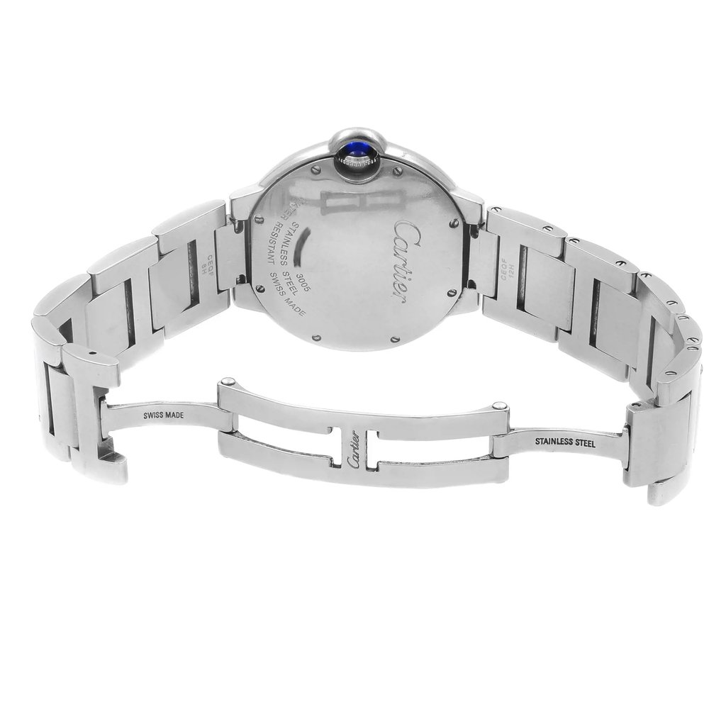 An image of a pre-owned Cartier unisex wristwatch in a back view with an open clasp. The watch features a round stainless steel case with a screwback, connected to a stainless steel band. The hidden fold clasp is partially extended. The watch is positioned centrally at a medium distance, with the watch face turned away from the viewer, displaying the Cartier name and "SWISS MADE" on the back. The photo is taken at a slight angle to show the curvature of the band and the profile of the caseback.