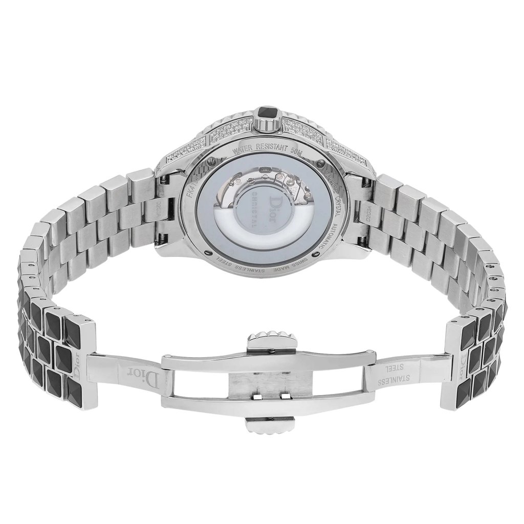 An image of a wristwatch photographed from the back view, showcasing its open clasp. The watch features a stainless steel bracelet, with a detailed view of the watch's inner mechanism visible through a transparent case back. The image is taken from a close distance, highlighting the intricate design and craftsmanship of the timepiece. The bracelet is partially folded, providing a clear view of the open clasp mechanism.