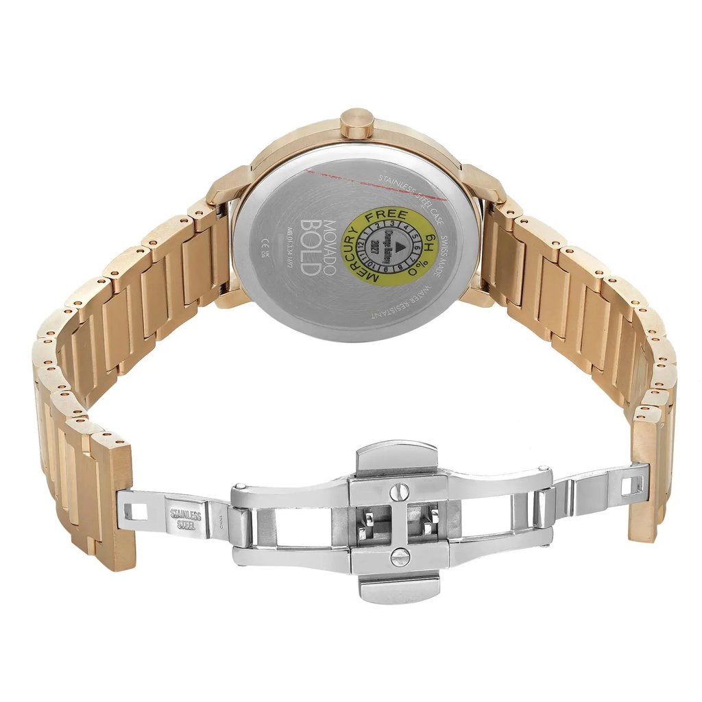 An image of a pre-owned wristwatch showing the back view with an open clasp. The watch is positioned upright, displaying its metallic back cover with branding and information visible. The gold-toned metal strap is spread open, with the silver clasp unfastened and centered in the foreground. The angle is slightly elevated, providing a clear view of the watch's back and open band from a moderate distance.