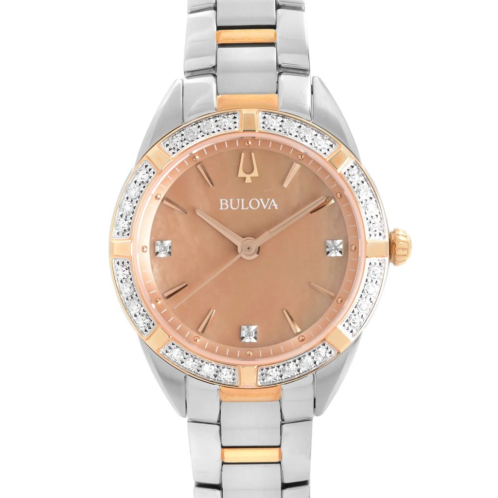 An image of a new Bulova women's wristwatch with a slight defect, presented in a front close-up shot that focuses on the watch face. The round dial is bronze-colored with a Mother of Pearl pattern, featuring diamond markers and stick indexes under a rose gold-tone bezel adorned with diamonds. The stainless steel band combines silver and rose gold-tone elements, and the watch is styled for dress/formal occasions. The distance and angle provide a clear view of the watch's details, with the face centered in the frame.
