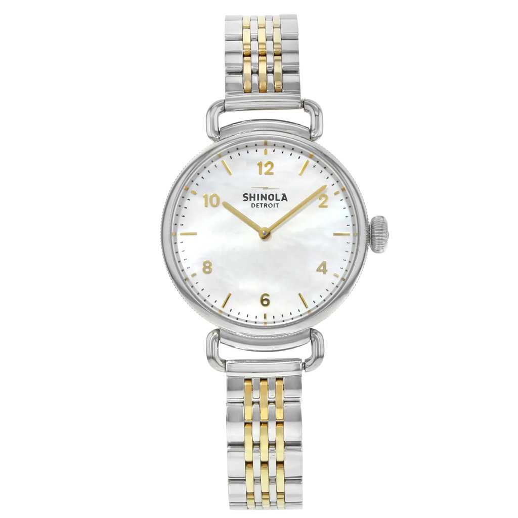 An image of a Wristwatch by Shinola. This Pre Owned item is designed for Women, featuring a Dress/Formal style. It has a Quartz movement and an Analog display with a Multicolor dial color. The indices include 12-Hour Dial,Arabic Numerals,Stick Indexes. The band is made of Stainless Steel and the case is made of Stainless Steel. The watch has a Round shape with a case size of 32 mm and a case thickness of 10 mm.