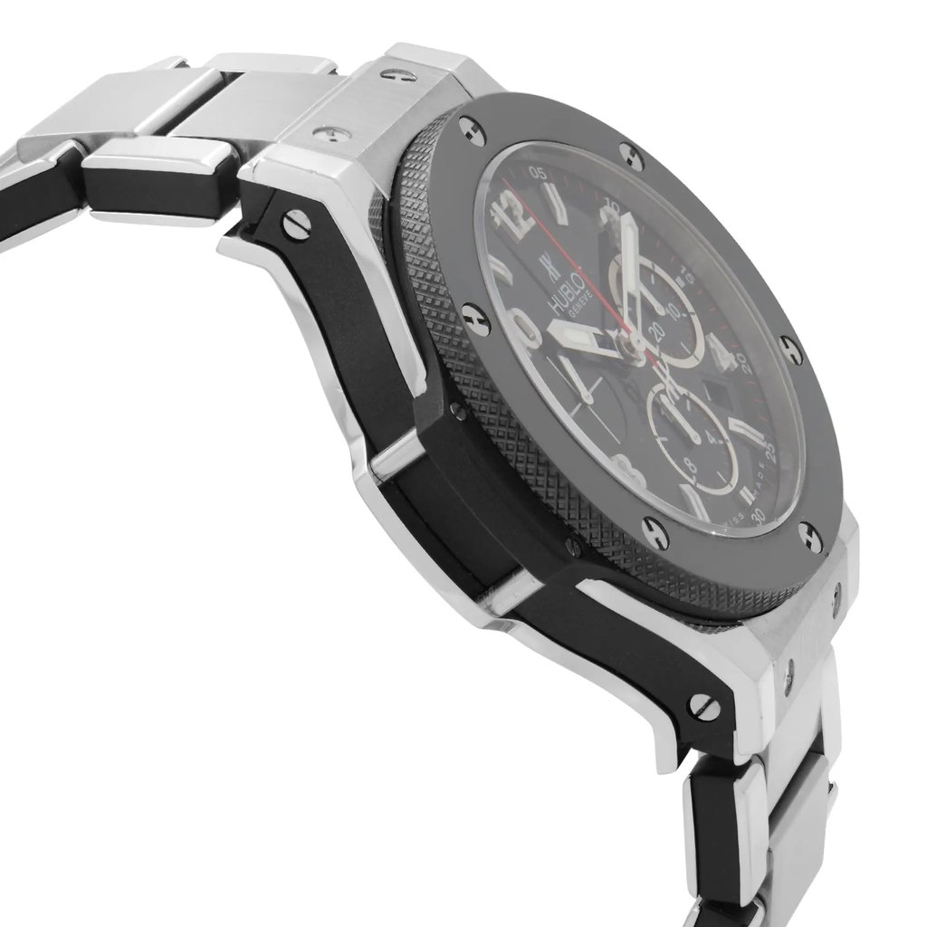An image of a pre-owned wristwatch viewed from a side profile opposite the crown. The watch features a metallic bracelet and a textured bezel. The angle highlights the watch's thickness and the design of its lugs, with the face partially visible showing some of the dial details. The photo is taken at a close distance to emphasize the watch's craftsmanship and condition.