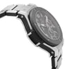 An image of a pre-owned wristwatch viewed from a side profile opposite the crown. The watch features a metallic bracelet and a textured bezel. The angle highlights the watch's thickness and the design of its lugs, with the face partially visible showing some of the dial details. The photo is taken at a close distance to emphasize the watch's craftsmanship and condition.