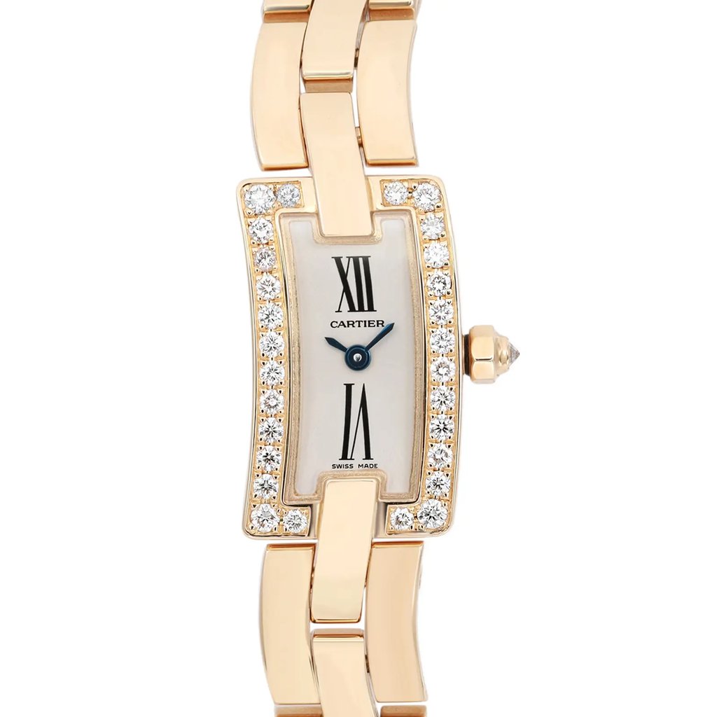 An image of a pre-owned wristwatch taken from a front close-up angle, focusing on the watch face. The watch features a rectangular dial adorned with Roman numerals and surrounded by a border of sparkling stones. The band is a shiny metallic finish. The brand name is visible on the dial.