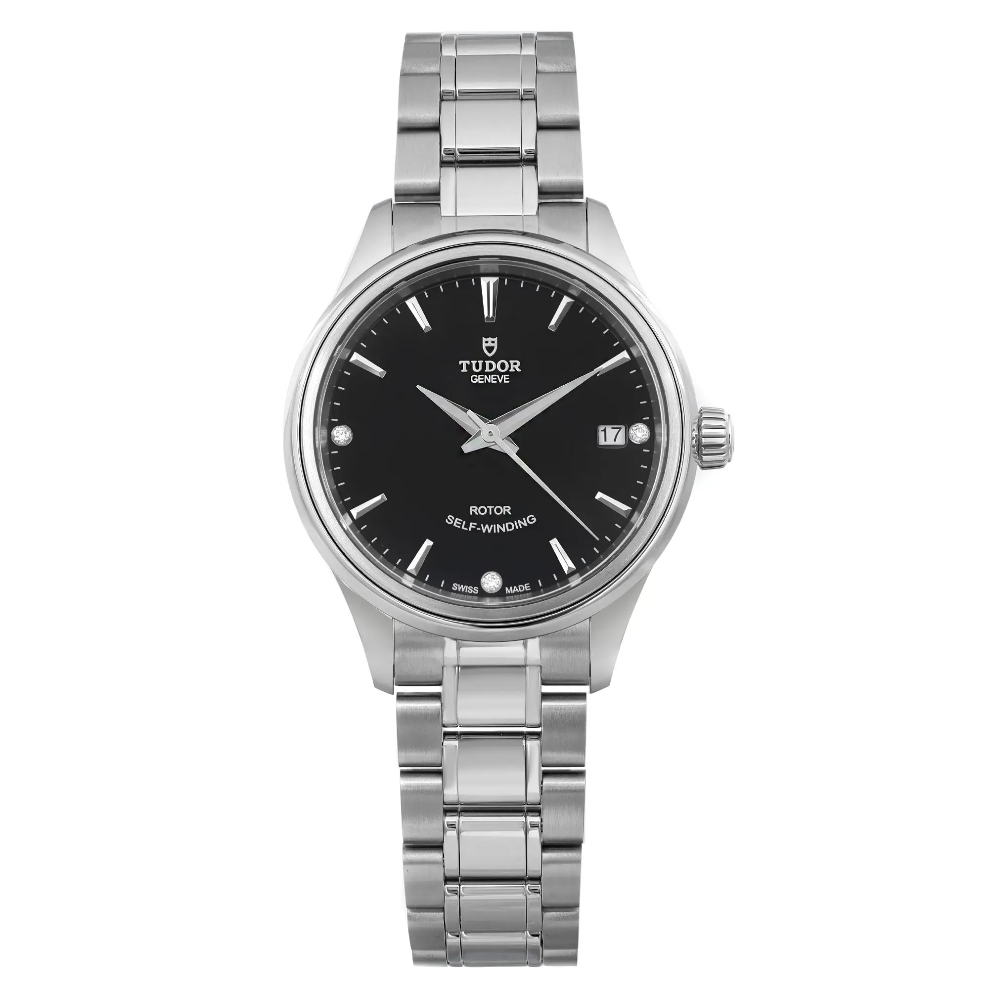 The image presents a close-up, straight-on view of a ladies' TUDOR Style 34mm wristwatch. This watch boasts a sleek diamond black dial with a date indicator located at the 3 o'clock position. The unworn stainless steel bracelet and case display a polished finish. The brand name and the text "Rotor Self-Winding" can be seen on the dial.