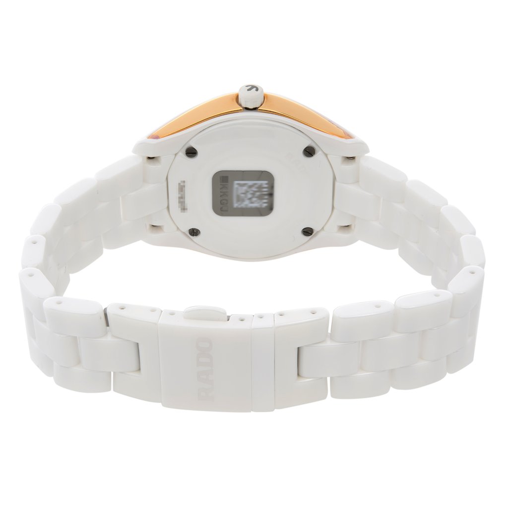 An image of a wristwatch taken from the back view, showcasing the closed clasp. The watch features a white ceramic band and a round case. The back of the case displays a small square with a QR code and some text. The angle is slightly elevated, and the distance is close, emphasizing the details of the clasp and bracelet links. The condition appears to be a display model with no visible wear.