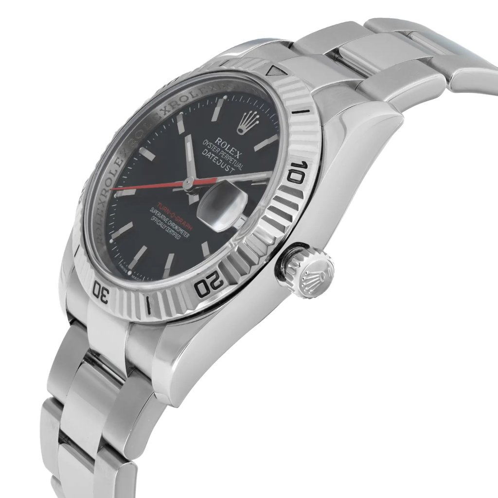 An image of a pre-owned wristwatch shown from a side profile view. The focus is on the crown, which is visible and positioned on the right side. The angle highlights the metallic bracelet and the watch face with a visible date magnifier. The watch is positioned at a slight angle, emphasizing its sleek design and polished finish.