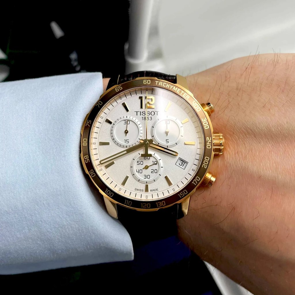 Front View Of Tissot T095.417.36.037.00 Stainless Steel Watch Being Worn In A Men's Wrist With A Light Blue Dress shirt