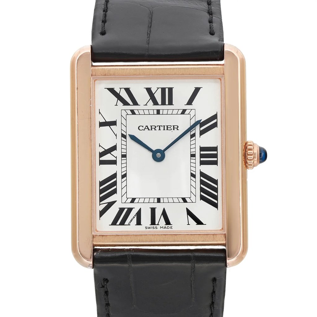 An image of a pre-owned Cartier luxury wristwatch for women, presented in a front close-up view highlighting the watch face. The watch features a silver dial, Roman numeral indices, and blue hands, enclosed in a rose gold rectangular case with minor signs of wear. The bezel is also rose gold, and it is attached to a black leather band. The watch is positioned straight on at a close distance, offering a clear view of the dial and Cartier branding.