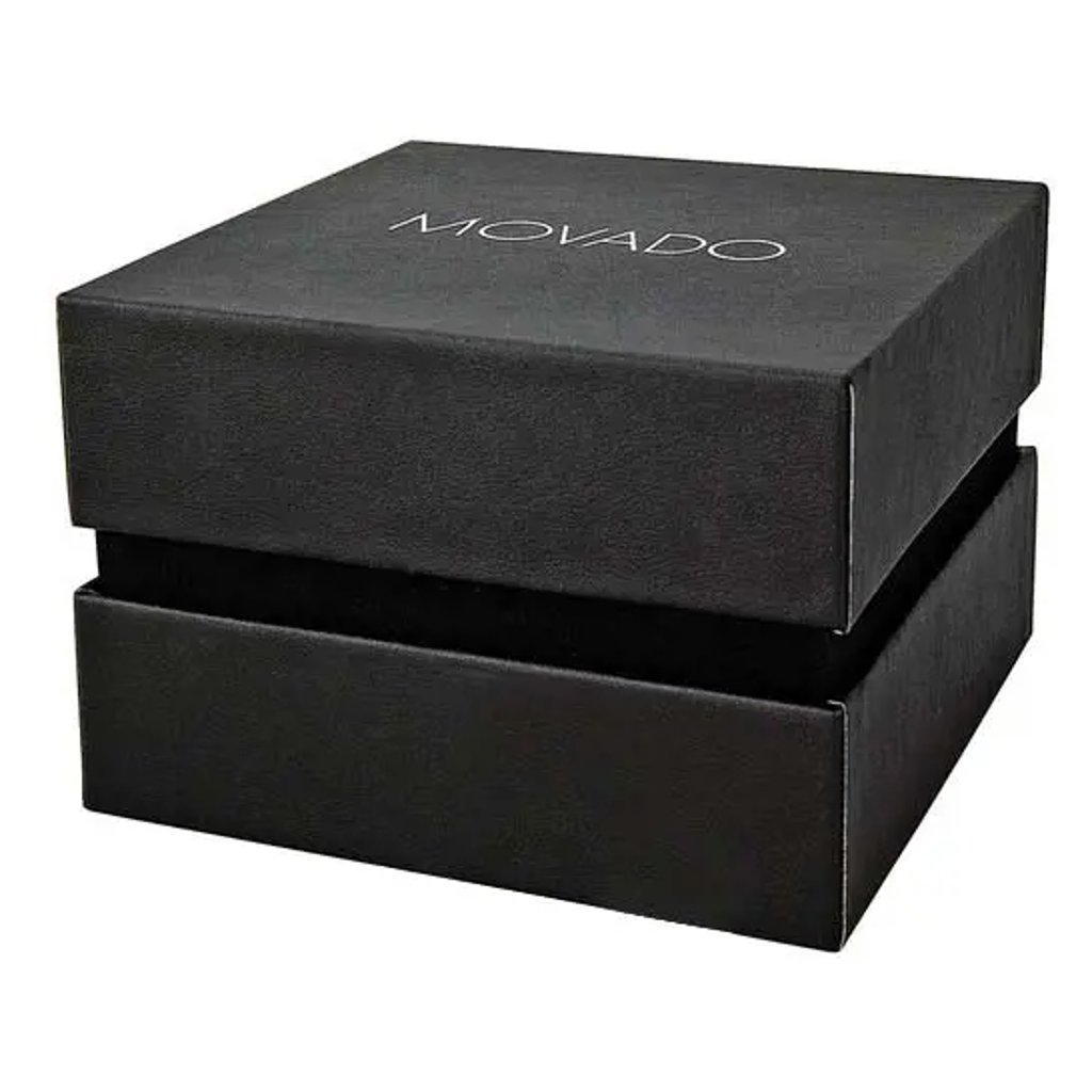 An image of a wristwatch box, shown in a full view. The box is positioned centrally and slightly angled to the right, with the lid partially open. The box is black with the brand name "MOVADO" printed on the top in white. The image is taken from a close distance, highlighting the texture and design of the box.