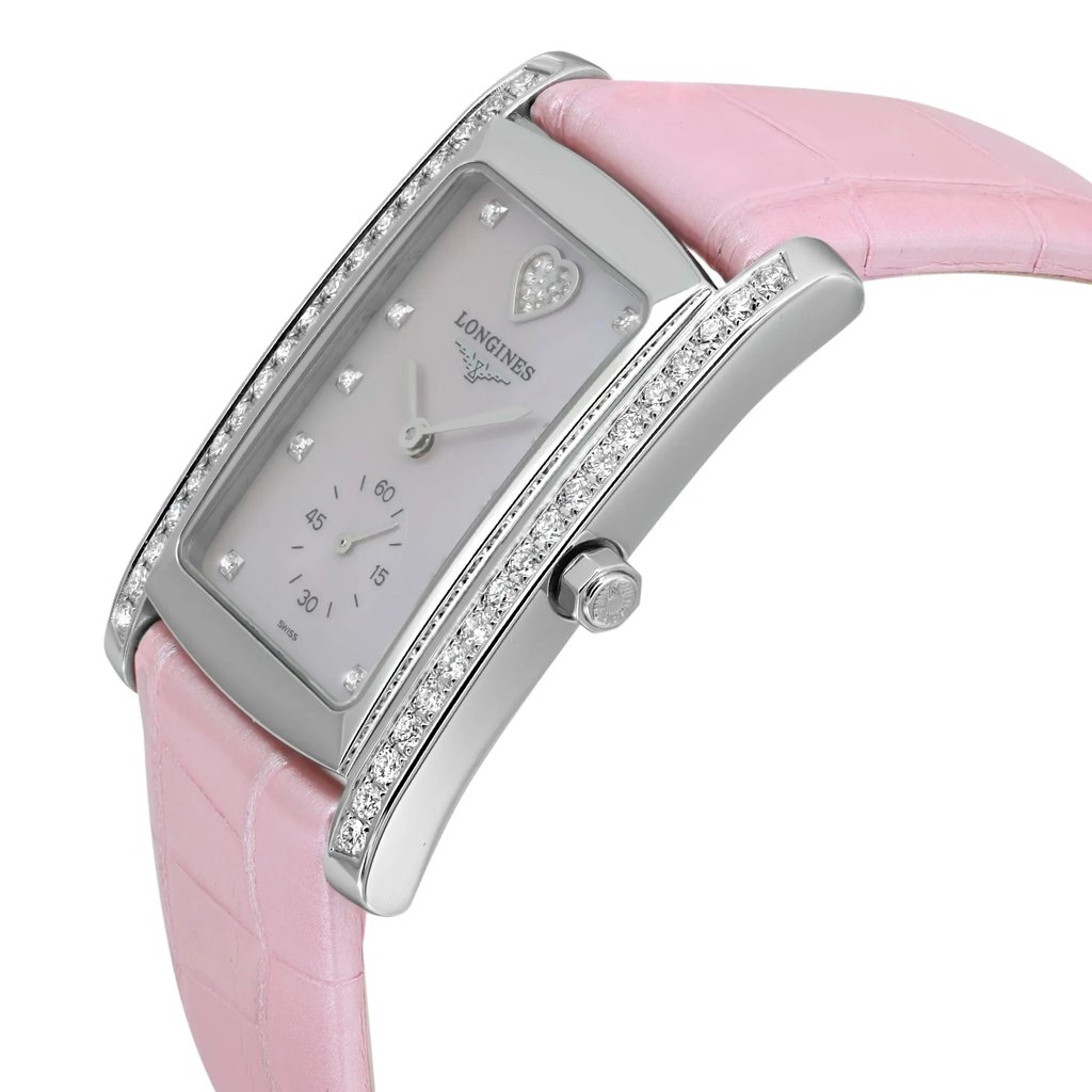 An image of a wristwatch in an unworn condition, showcasing a side profile view. The watch features a pink leather strap and a rectangular, silver-toned case adorned with small, sparkling stones along its edges. The crown is prominently visible on the side. The dial is minimalistic with a subtle heart design and silver hour markers. The photograph captures the watch from a close distance, highlighting its elegant craftsmanship and luxurious detailing.