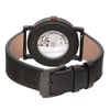 An image of an unworn Bvlgari men's wristwatch with a Black DLC stainless steel round case and an exhibition caseback, viewed from the back at a straight angle. The watch features a dark brown leather band with a buckle closure, and the clasp is in a closed position. The image is taken from a close distance, highlighting the craftsmanship of the watch and the branding on the caseback.