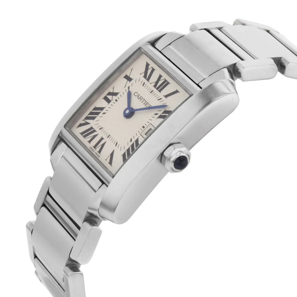 An image of a pre-owned women's Cartier wristwatch, viewed from a slight angle that shows both the face and part of the bracelet. The watch has a rectangular face with Roman numerals and a date indicator. The hands are blue, and the casing is stainless steel, complementing the polished bracelet. The angle highlights the side crown, with the watch positioned closely for detailed viewing.