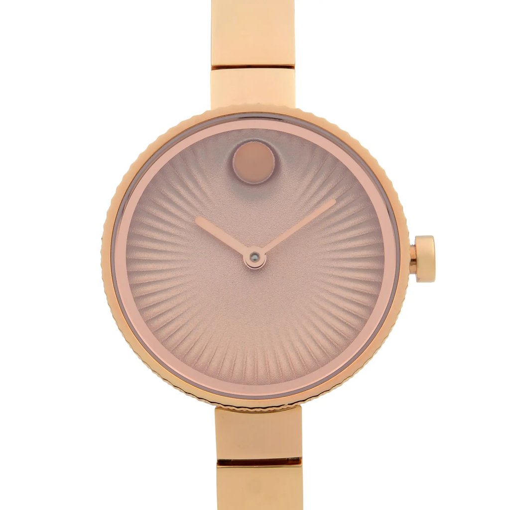 An image of a wristwatch taken from a front close-up angle, highlighting the watch face. The watch features a circular design with a textured dial and minimalistic hands. The case and strap are gold-toned, with the crown positioned on the right side. The condition appears pre-owned.