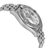 An image of an unworn Breitling women's wristwatch, captured from a side profile opposite to the crown. The watch features a luxurious round stainless steel case with a mother of pearl dial in white, accented with a gray bezel. It showcases luminous hands, a date indicator, and is attached to a stainless steel band. The original protective sticker is visible on the case, indicating its pristine condition. The watch is positioned at a slight angle to the camera, providing a clear view of its side profile and curvature of the band.