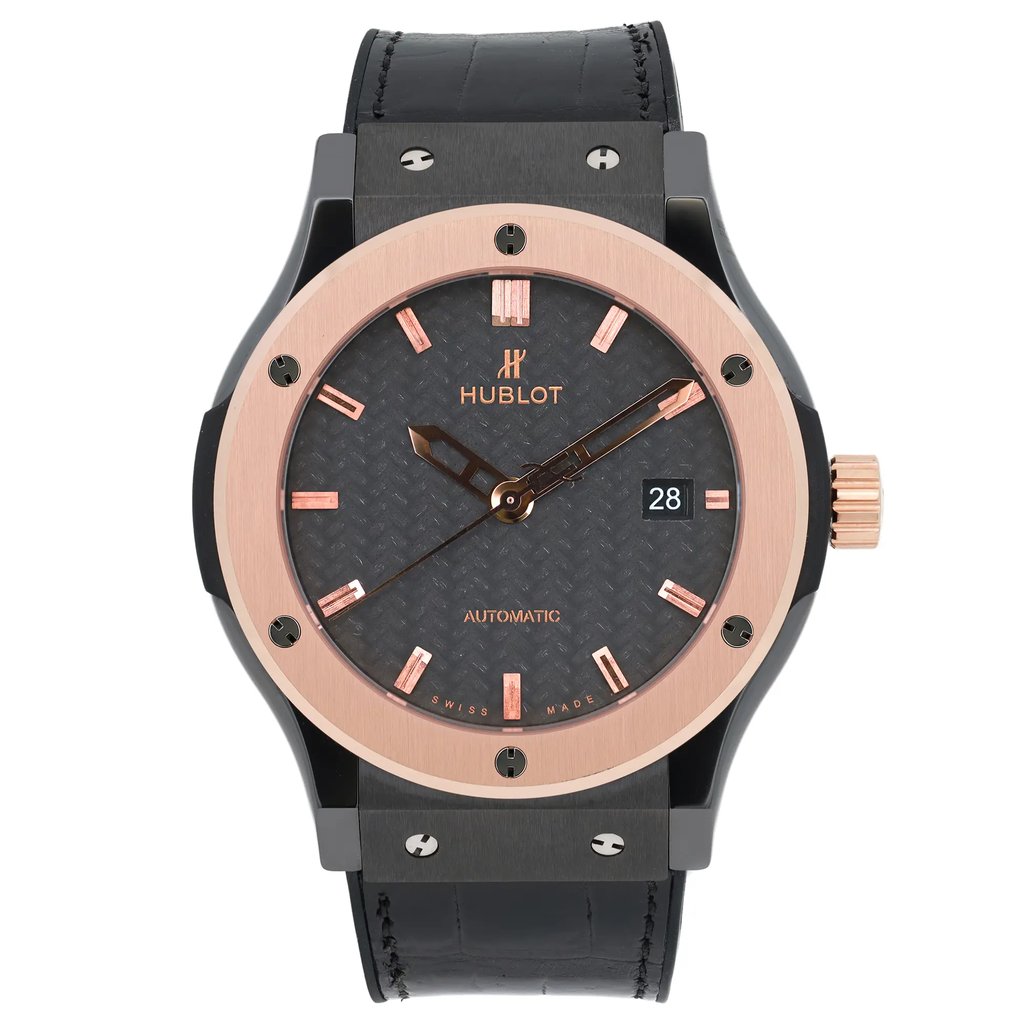An image of a pre-owned men's Hublot Classic Fusion Ceramic King 18K Rose Gold Black Dial Watch  captured from a frontal angle at a close distance. The watch features a black leather strap and a round face with a rose gold bezel. The dial is dark with rose gold hour markers and hands, and includes a date indicator at the 3 o'clock position.