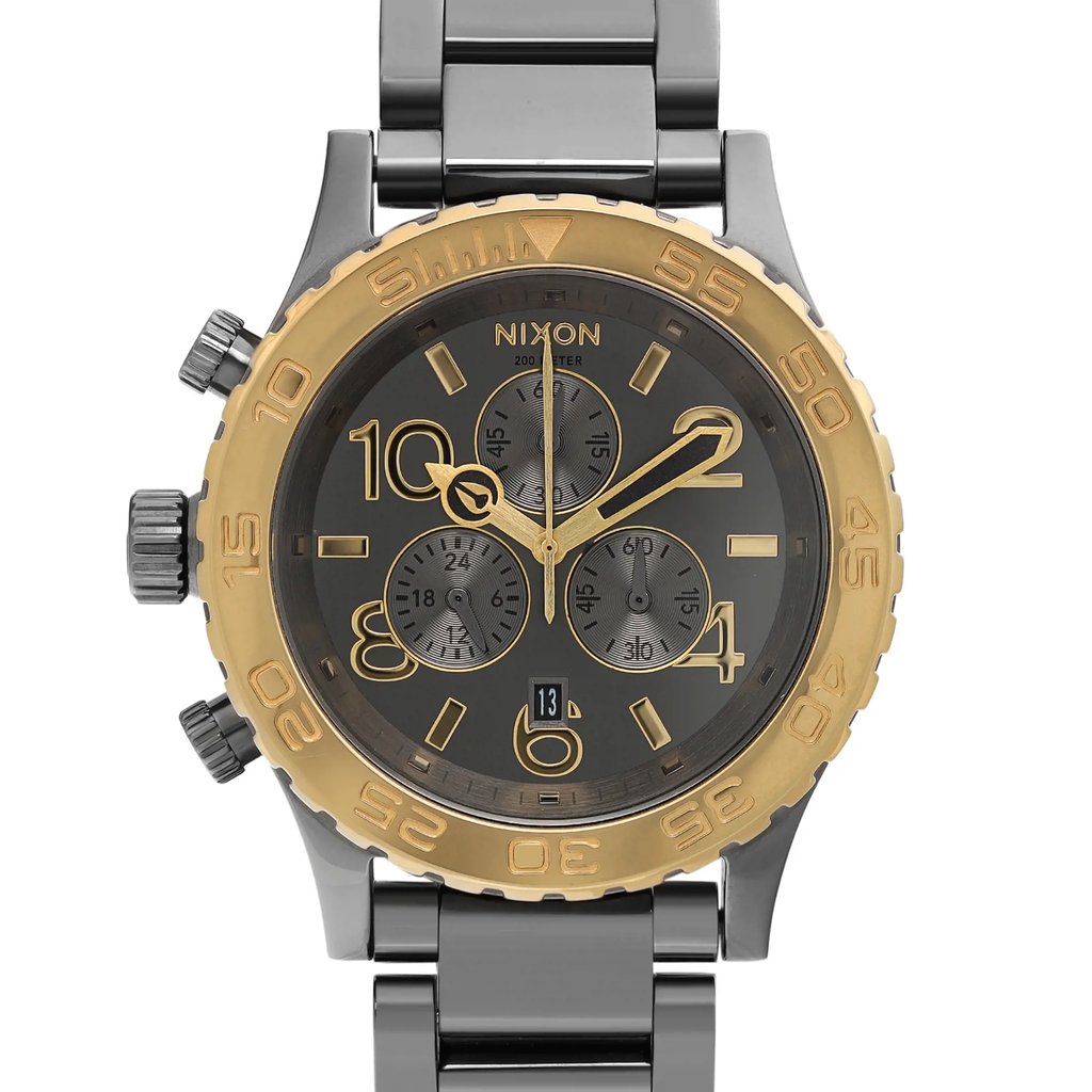 An image of a Wristwatch by Nixon. This Pre Owned item is designed for Men, featuring a Classic style. It has a Quartz movement and an Analog display with a Gunmetal Grey dial color. The indices include 12-Hour Dial,Easy to Read/Large Numerals,Seconds Hand. The band is made of Stainless Steel and the case is made of Stainless Steel. The watch has a Round shape with a case size of 42 mm and a case thickness of 13 mm.