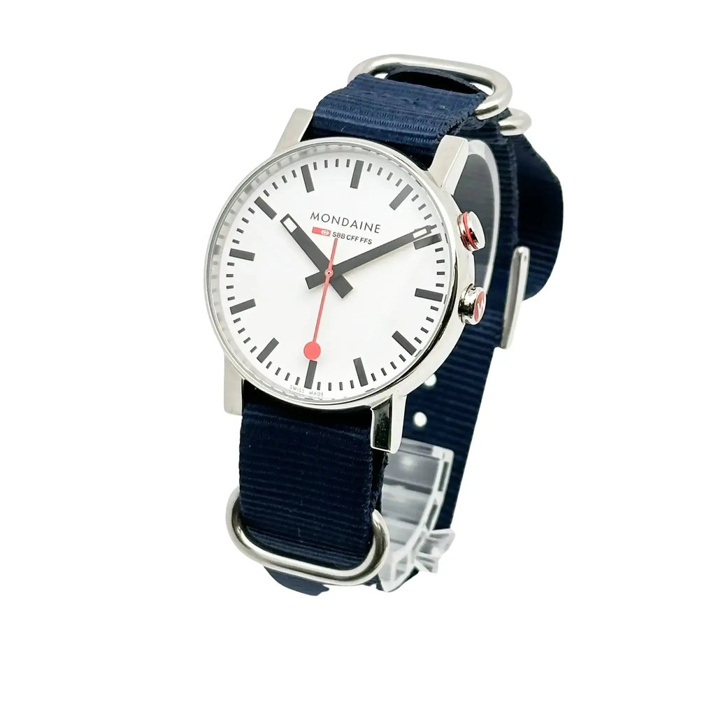 An image of a Wristwatch by Mondaine. This Pre Owned item is designed for Men, featuring a Casual,Classic style. It has a Quartz movement and an Analog display with a White dial color. The indices include 12-Hour Dial,Stick Indexes. The band is made of Nylon and the case is made of Stainless Steel. The watch has a Round shape with a case size of 40 mm and a case thickness of 12 mm.
