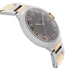 An image of a pre-owned Cartier luxury wristwatch for men, viewed from a side profile opposite the crown. The watch features a round case made of stainless steel and a dial with a sunburst brown pattern. Roman numerals are visible on the dial. It has a steel bezel and a bracelet composed of stainless steel with 18k rose gold inserts. The watch is positioned at a slight angle, with the watch face taking center stage and the band curving away into the background.