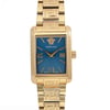 An image of a Wristwatch by Versace. This Display Model item is designed for Women, featuring a Dress/Formal style. It has a Quartz movement and an Analog display with a Blue dial color. The indices include 12-Hour Dial,Non-Numeric Hour Marks,Roman Numerals. The band is made of Gold Plated,Stainless Steel and the case is made of Gold Plated,Stainless Steel. The watch has a Rectangle shape with a case size of 23 mm and a case thickness of 8 mm.