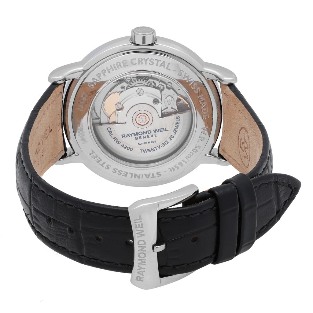 An image of a Raymond Weil men's wristwatch viewed from the back, showcasing the exhibition caseback. The stainless steel case and round shape are visible, with the inner mechanics prominently displayed. The black leather band is open, highlighting the buckle closure, and the watch is in excellent condition as a display model. The image is taken at a close angle, focusing on the clasp and back details.