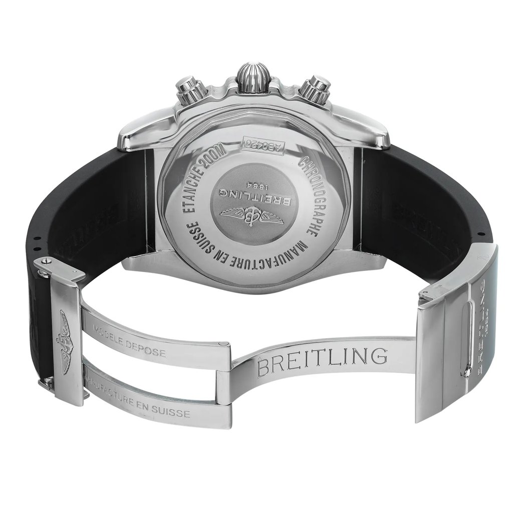 An image of a pre-owned Breitling men's wristwatch, viewed from the back with an open deployant clasp. The watch is positioned centrally and shot from a direct, level angle, with the camera's distance allowing to capture the entire back view of the watch. The caseback is screwback stainless steel, engraved with branding and watch specifications, while the black rubber band connects to a stainless steel clasp inscribed with the brand's name. The watch is round in shape, showcasing the contrasting materials and design details. The band may show light signs of wear.