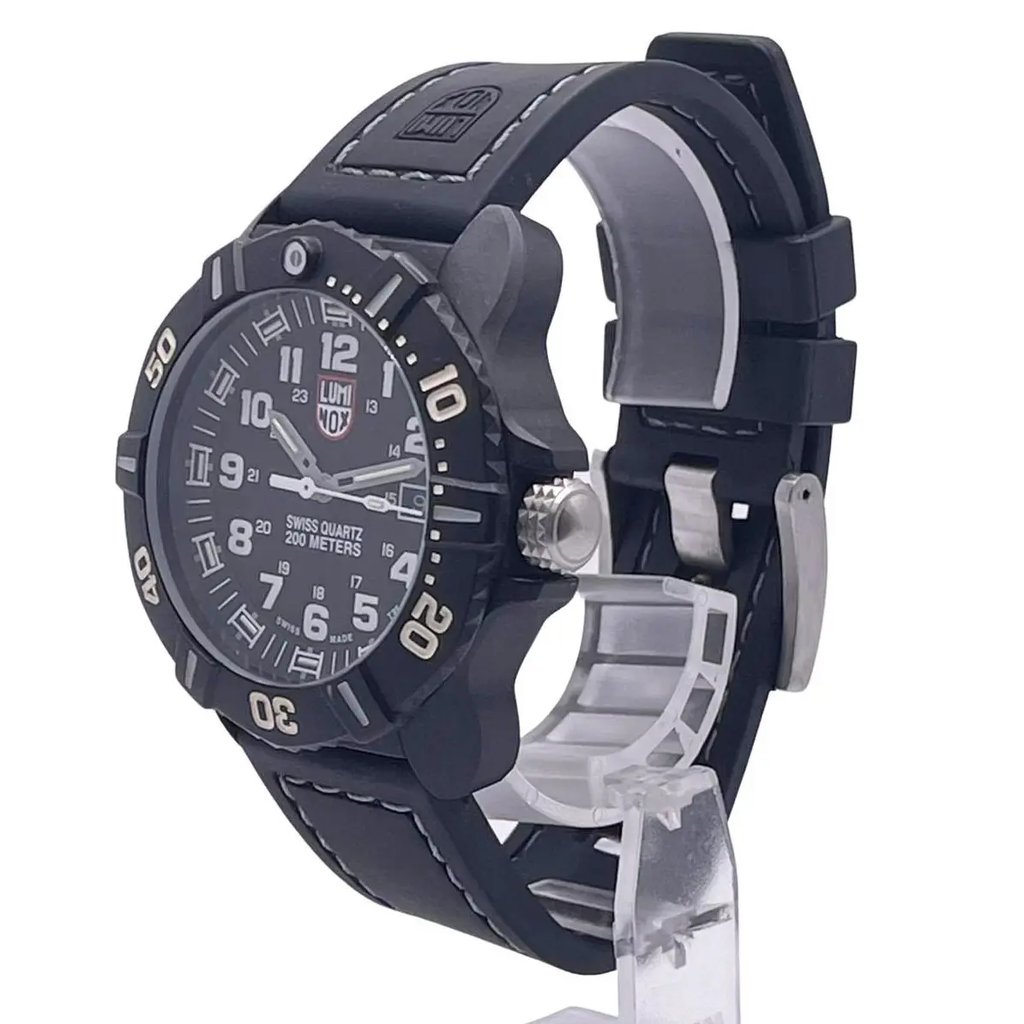 An image of a Wristwatch by Luminox. This Pre Owned item is designed for Men, featuring a Diver style. It has a Quartz movement and an Analog display with a Black dial color. The indices include 12-Hour Dial,24-Hour Dial,Arabic Numerals. The band is made of Silicone and the case is made of carbon. The watch has a Round shape with a case size of 44 mm and a case thickness of 15 mm.