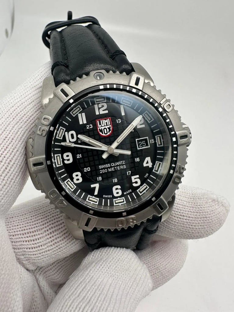 An image of a Wristwatch by Luminox. This Pre Owned item is designed for Men, featuring a Casual,Dress/Formal,Military style. It has a Quartz movement and an Analog display with a Black dial color. The indices include 12-Hour Dial,Arabic Numerals,Easy to Read/Large Numerals. The band is made of Leather and the case is made of Stainless Steel. The watch has a Round shape with a case size of 45 mm and a case thickness of 14 mm.