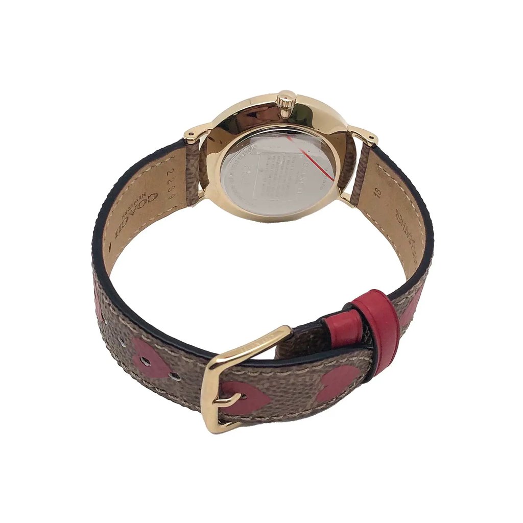 An image of a Wristwatch by Coach. This Display Model item is designed for Women, featuring a Classic style. It has a Quartz movement and an Analog display with a Gold dial color. The indices include 12-Hour Dial,Stick Indexes. The band is made of Canvas,Leather and the case is made of Stainless Steel. The watch has a Round shape with a case size of 36 mm and a case thickness of 8 mm.