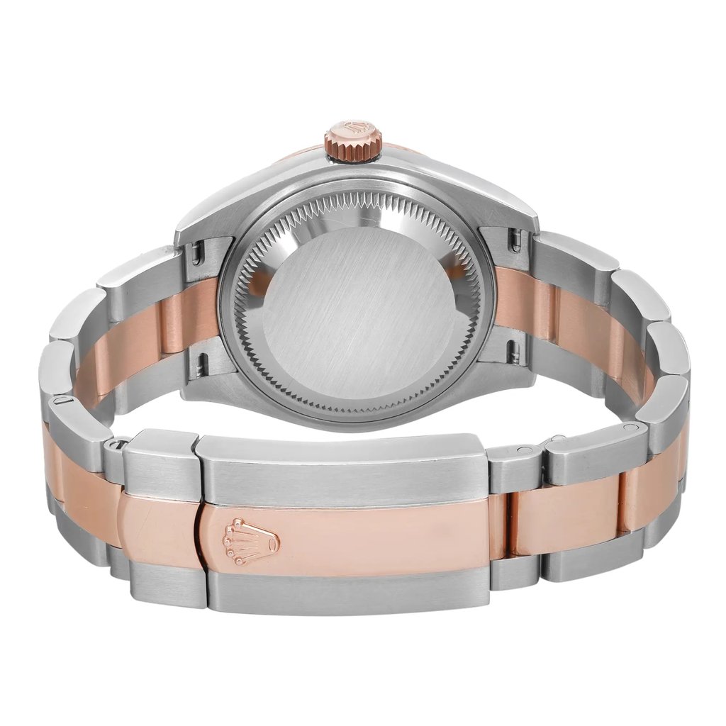 An image of a pre-owned Rolex women's wristwatch viewed from the back, showing the screwback case and the fold-over clasp closure. The watch is positioned horizontally in the center of the frame, with a close-up angle that provides a clear view of the materials. The case is made of stainless steel and the band features a combination of stainless steel and rose gold, reflecting a luxurious two-tone design. 