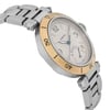 An image of a pre-owned Cartier men's wristwatch, captured at a slight angle from the top right. The watch features a round face with a yellow gold bezel and a stainless steel  bracelet. The face displays a date indicator and luminous hands. The angle highlights the side profile and bracelet links, providing a close-up view.