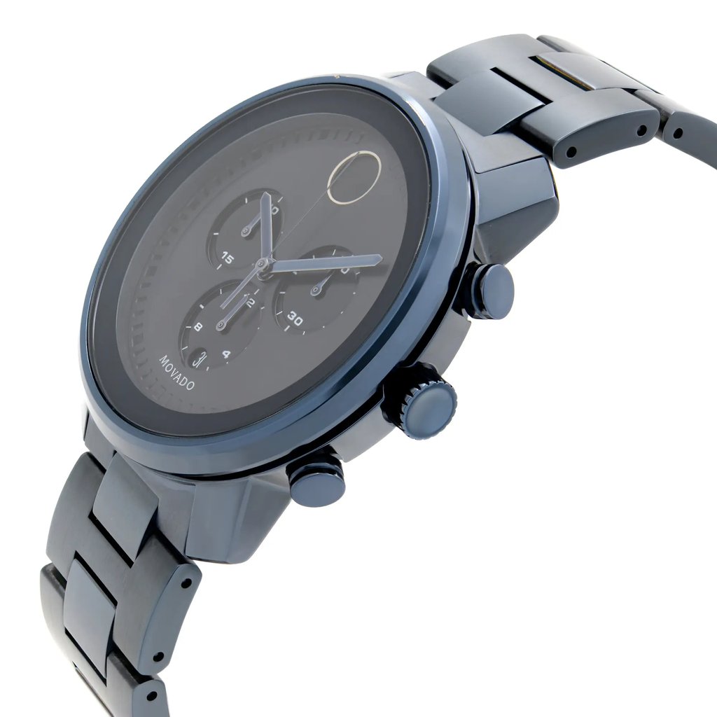 An image of a pre-owned wristwatch taken from a side profile view, showcasing the crown prominently. The angle highlights the sleek design and the detailing on the watch face, with the band extending outwards. The photo is taken from a close distance, emphasizing the watch's metallic finish and craftsmanship.