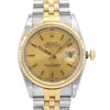 An image of a pre-owned wristwatch taken as a front close-up shot of the watch face. The watch features a gold and silver two-tone design with a fluted bezel. The face is gold with simple hour markers and a date window at the 3 o'clock position. The bracelet is a combination of gold and silver links.