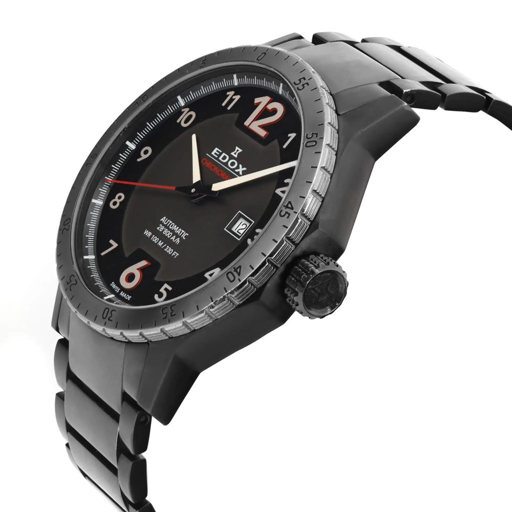 An image of a pre-owned wristwatch viewed from a side profile angle, highlighting the crown. The watch features a dark dial with prominent numerals and hands, enclosed in a metallic case. The bracelet is visible, showcasing its link design. The photo is taken at a close range, capturing the intricate details of the watch’s craftsmanship.