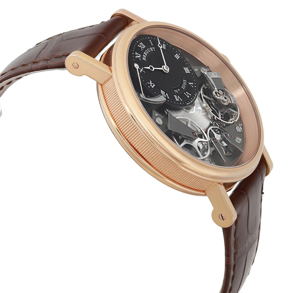 An image of a pre-owned luxury Breguet men's wristwatch captured from a side profile view, opposite the crown. The watch features a round gray dial with a rose gold bezel and a leather band. The case is made of rose gold, showcasing the intricate mechanics visible on the dial, including a power reserve indicator. The angle highlights the watch's elegant design and craftsmanship.
