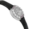An image of a pre-owned Audemars Piguet women's wristwatch positioned at a slight angle, showcasing the watch face and part of the strap. The watch has a round MOP dial surrounded by sparkling diamonds and purple gemstones. The black leather strap is partially visible. The image captures the watch from a close-up perspective, highlighting its elegant details and luxurious design.