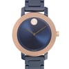 An image of a wristwatch taken from a front close-up angle, showcasing the watch face. The watch features a sleek, dark blue dial with minimalistic design, complemented by a metallic rose gold bezel. The timepiece is a display model, and the brand name is visible at the bottom of the dial.