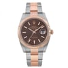 An image of a pre-owned Rolex wristwatch for men presented in a full frontal view. The watch is positioned centrally with a slight angle that showcases the round watch face and band from a close distance. It features a luxurious chocolate-colored dial with rose gold bezel and a combination of rose gold and stainless steel on the band. The case material is stainless steel. The watch also displays a date indicator at the 3 o'clock position and has luminous hands. Despite being pre-owned, the watch is in excellent condition with only minor signs of wear or scratches.