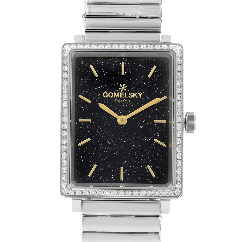 An image of a wristwatch taken from a front close-up angle, showcasing the rectangular watch face. The face is adorned with a dark, starry pattern and features gold hour markers and hands. The case is embellished with a row of small clear stones around the perimeter. The watch is in unworn condition and attached to a metallic bracelet. The crown is visible on the right side.