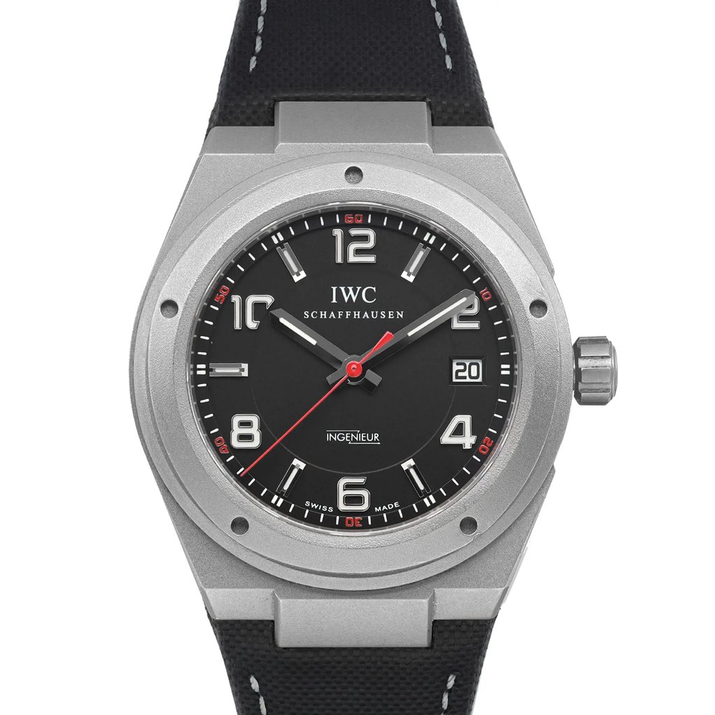 An image of a pre-owned wristwatch captured in a front close-up shot, focusing on the watch face. The watch features a black dial with bold white numerals and silver hour markers. The minute and hour hands are silver, while the second hand is red. The watchcase is metallic with a textured black strap, and there is a date window at the 3 o'clock position. The image emphasizes the watch's intricate details and design.